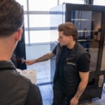 Monteur van Vending Master geeft op locatie professionele uitleg over de installatie en werking van een vendingautomaat aan klant, inclusief duidelijke instructies en advies voor optimaal gebruik